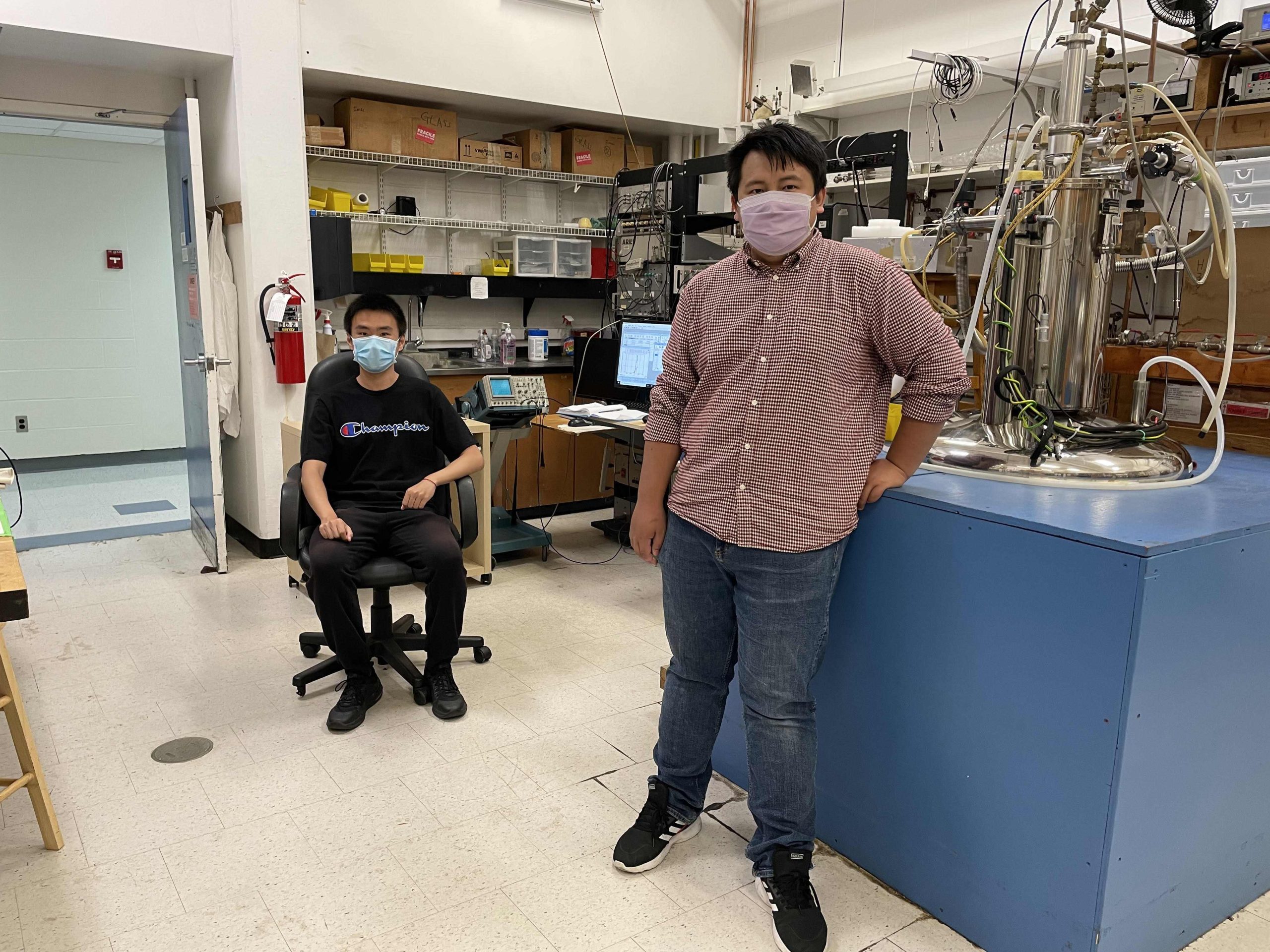 Ph.D. students Jerry Wang and Weishi Yuan in a lab