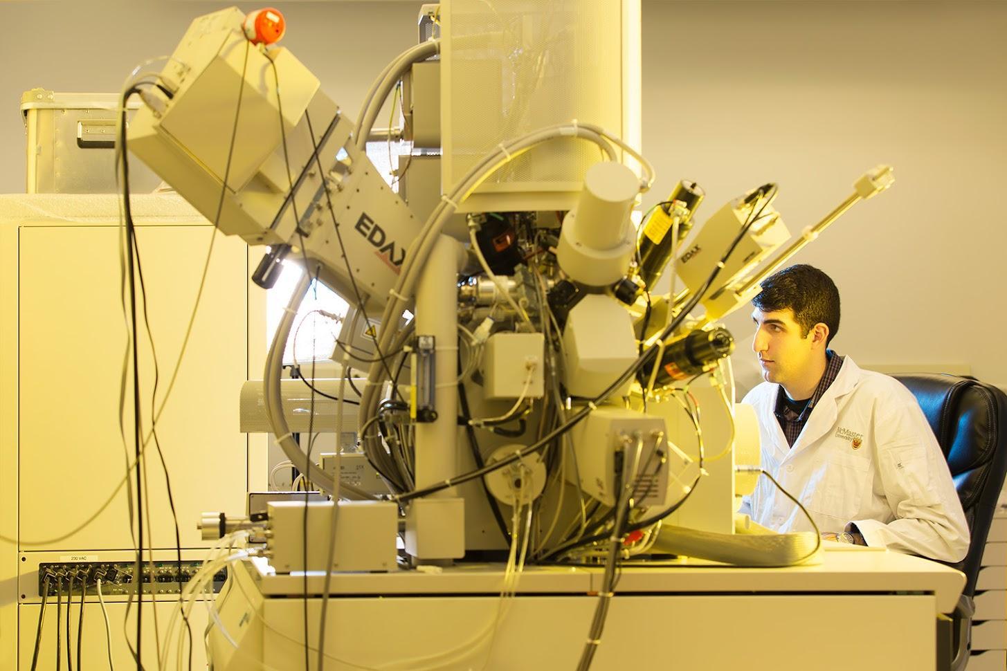 Researcher using an electron microscope.